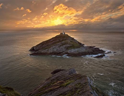 Sun rising over the Mumbles Lighthouse