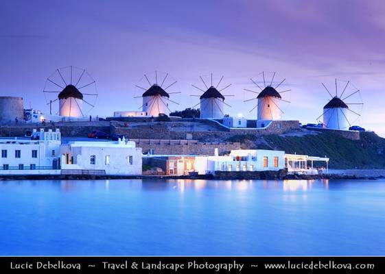 Greece - Cyclades - Mykonos - Chora - Iconic Windmills standing on hill overlooking area at Dusk - Twilight - Blue Hour