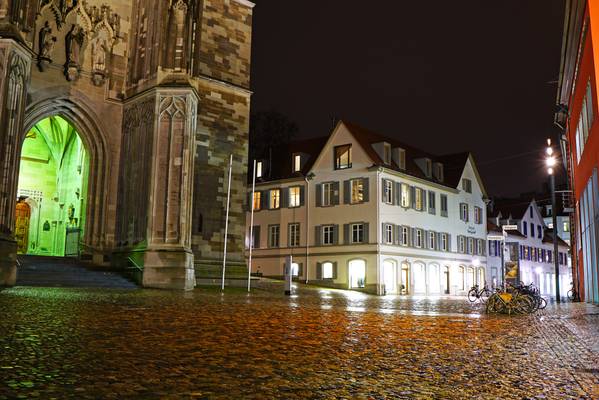 Konstanz by night. Wet cobblestone in front of the Cathedral