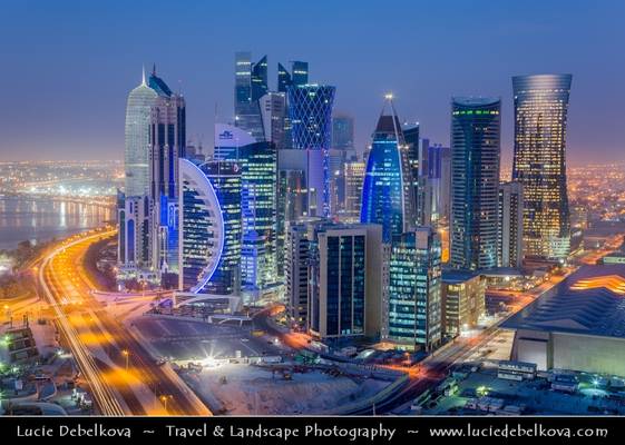 Qatar - Doha - New modern city skyline with illuminated skyscrapers at Dawn