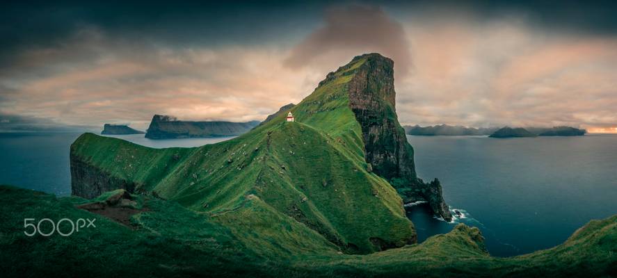 Panorama at Kalsoy lighthouse with cliffs during sunset, Faroe Islands