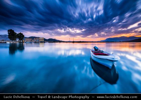 Albania - Butrint National Park - Sunset over laguna with fishing boat