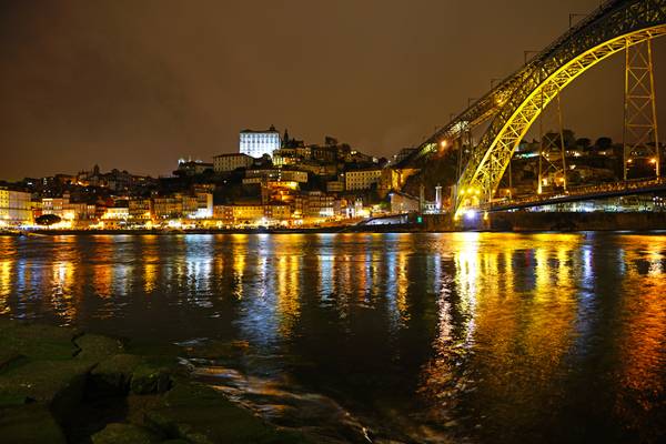 Porto by night. Reflections in Douro River