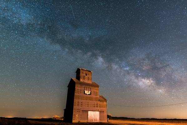 Milky Way rising over old abaondoned wooden elevator