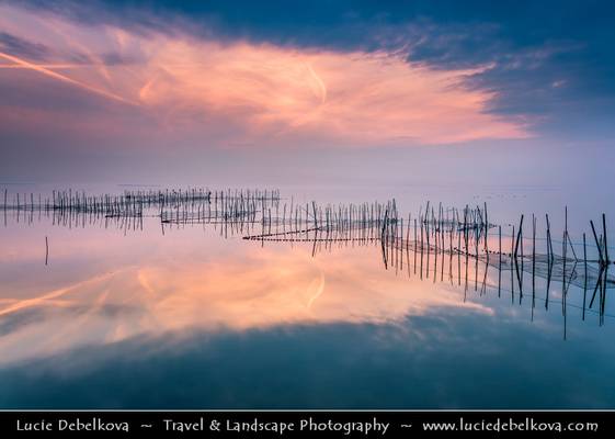 Spain - Valencia’s Albufera Natural Park - L'Albufera lake with fishing nets at Sunset
