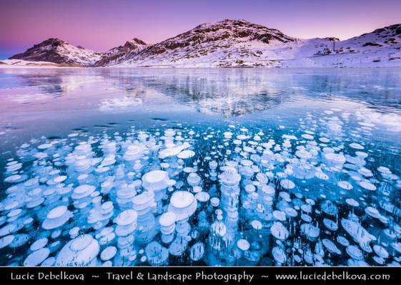 Switzerland - Alps - Deep frozen Lago Bianco - White Lake with surreal bubbles at Sunrise