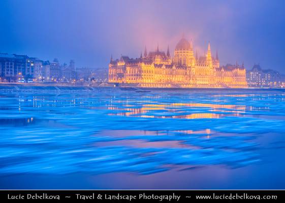 Hungary - Budapest - Hungarian Parliament Building - Iconic landmark reflected at Danube River full of floating ice