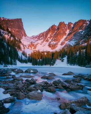 I watched as the rising sun set fire to the mountains surrounding Dream Lake in Rocky Mountain National Park — Colorado [OC] [1200x1500]