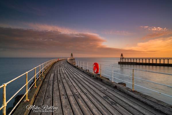 Whitby piers sunrise ..
