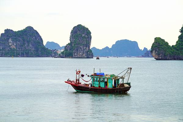 Lone fishing boat in Ha Long Bay, Vietnam