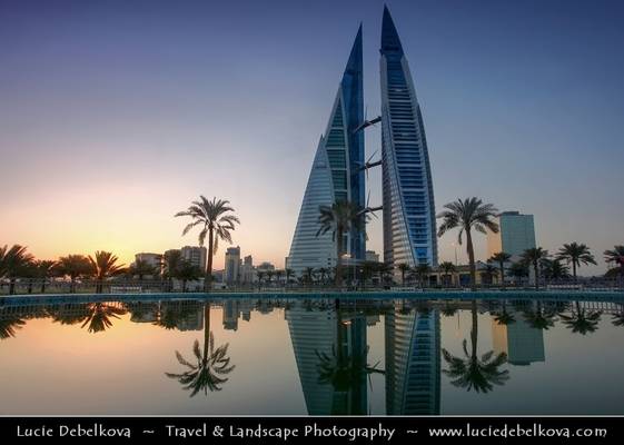 Bahrain - Sunrise next to Bahrain World Trade Center Reflected in Water Fountain