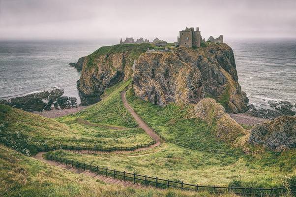 Dunnottar castle in a foggy evening