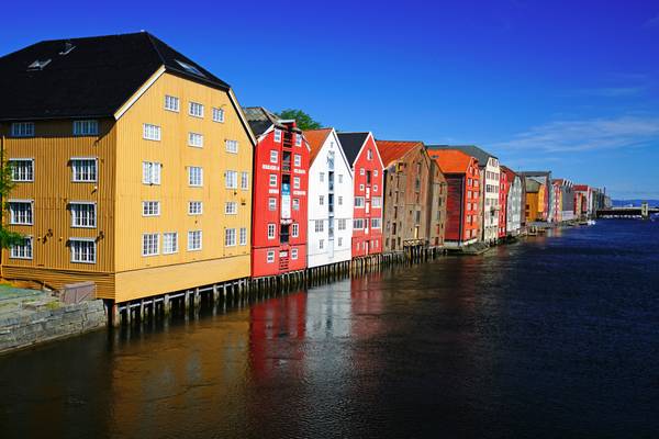 Fairy tale wooden houses reflecting in the river, Trondheim, Norway