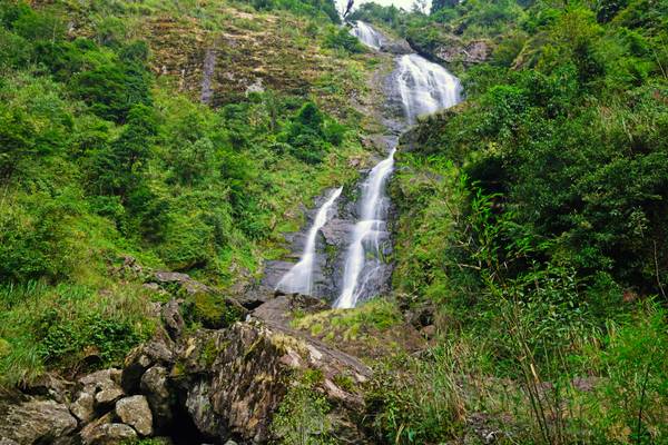 Waterfall running in the green hills, Sapa, Vietnam