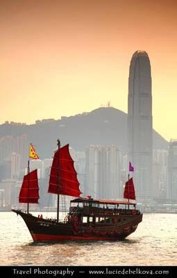 Hong Kong - Junk in Victoria Harbour and City Skyline at Sunset Time