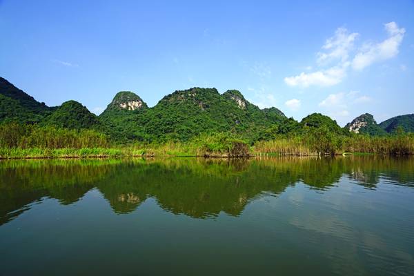 Green hills reflecting in Yen River, Vietnam