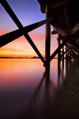Under a Pier, a Sunset Over Boston