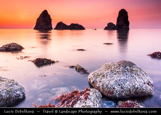 Italy - Sicily - Aci Trezza with the typical volcanic stacks on the shores of Mediterranean sea at Sunrise