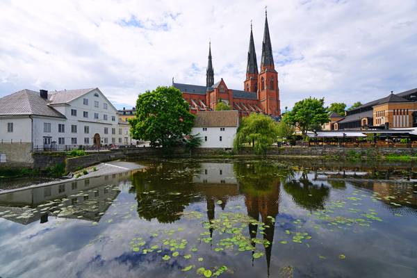 Uppsala Cathedral reflecting in Fyris river, Sweden