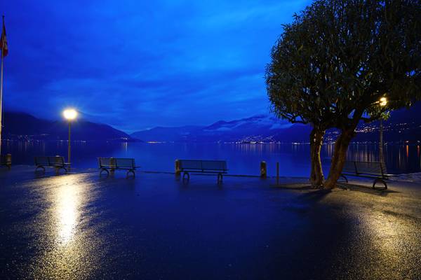 Ascona at the blue hour. Empty benches on the quay