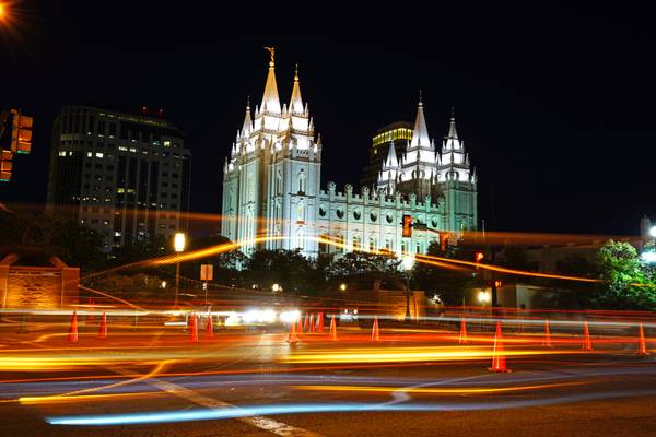 Salt Lake City by night. Traffic in front of the Salt Lake Temple