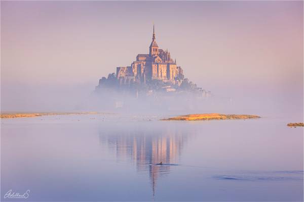Mont St Michel in early morning fog, France