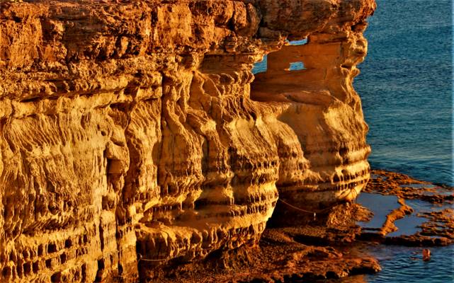 Rock windows at the Agia Napa sea caves at sunset