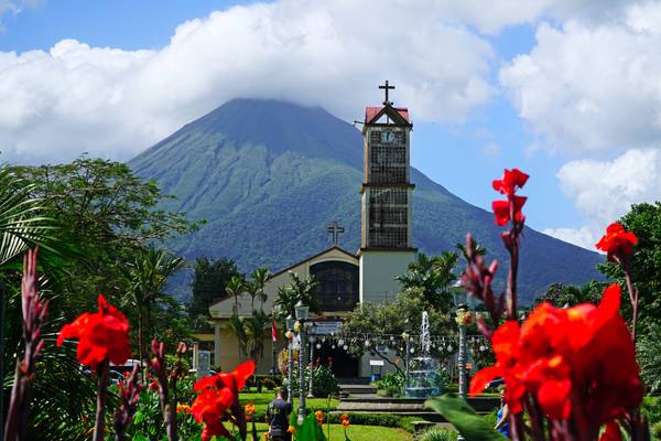 Iconic view of Volcano Arenal behind La Fortuna church, Costa Rica