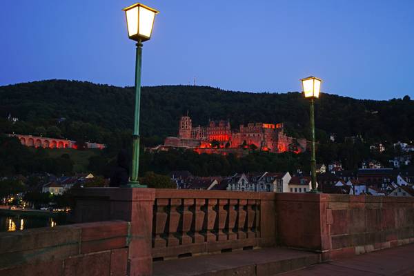 Heidelberg at the blue hour. The Castle between the Old Bridge street lamps